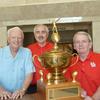 Coach Yeoman and two of the 1962 team members, Horst Paul and Paul Reinhardt, with the Tangerine Bowl Trophy.